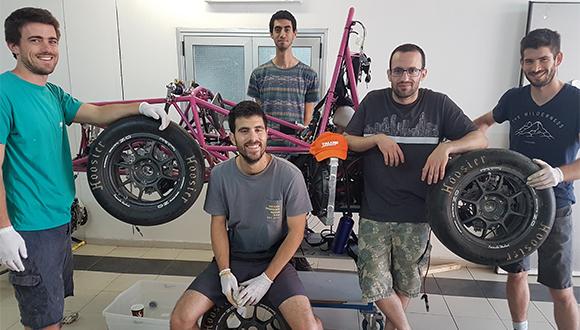 צוות הפורמולה בהרכב חסר ליד מכונית המרוץ צוות הפורמולה בהרכב חסר ליד מכונית המרוץ